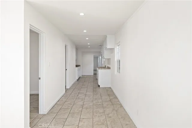 a view of a kitchen with white cabinets