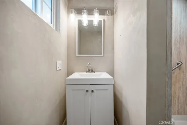 a bathroom with a shower and a sink