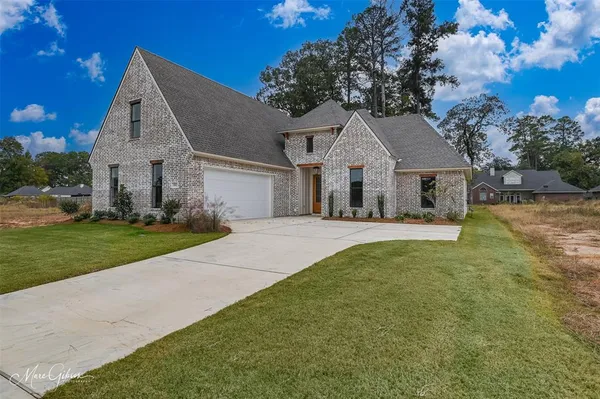 a front view of house with yard and green space