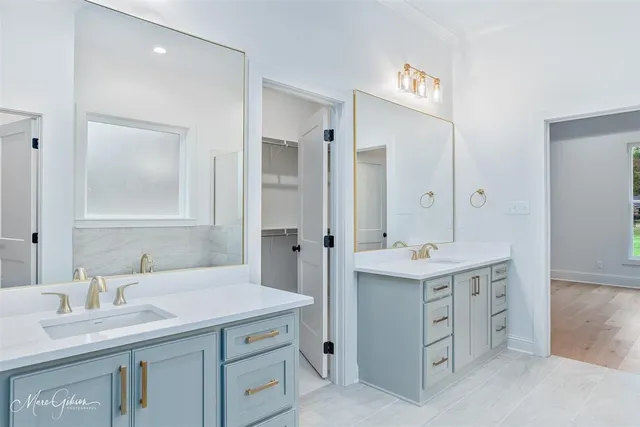 a bathroom with a sink double vanity and a mirror