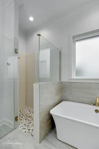a bathroom with a bathtub and shower