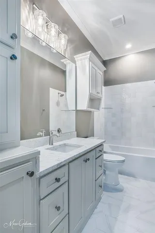 a bathroom with a toilet a sink a bathtub and a mirror