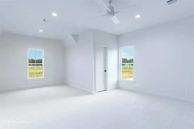an empty room with windows and closet