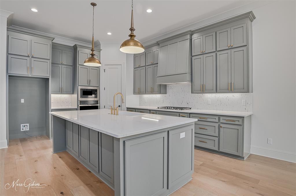 192 St Andrews Benton, LA 71006 - Photo 10 of 26 a kitchen that has a lot of cabinets in it and white stainless steel appliances
