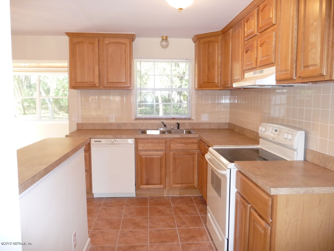 3384 Rogero Road Jacksonville, FL 32277 - Photo 5 of 17 a kitchen with a sink stove and cabinets