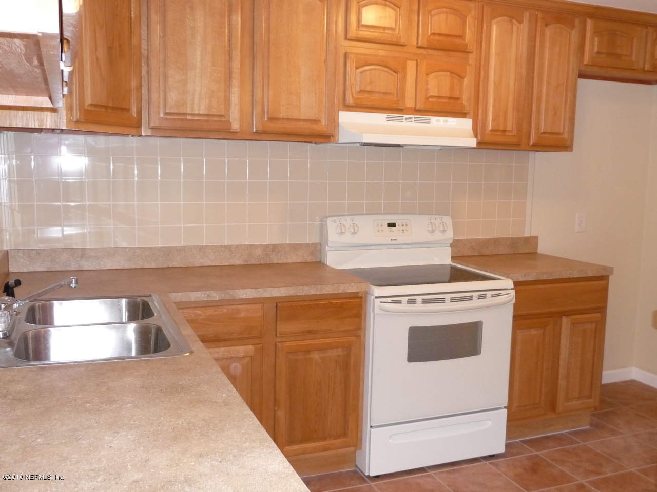 3384 Rogero Road Jacksonville, FL 32277 - Photo 6 of 17 a kitchen with granite countertop white cabinets and white appliances