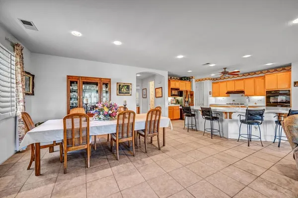 a large kitchen with stainless steel appliances granite countertop a sink and cabinets