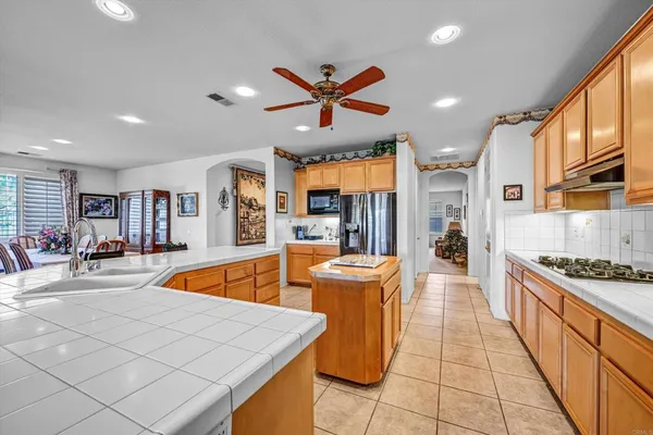 a kitchen with stainless steel appliances granite countertop a sink and a stove