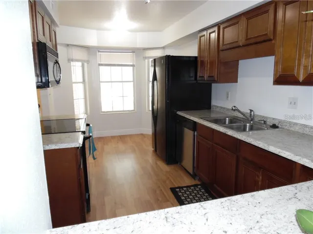 a kitchen with a refrigerator and a sink