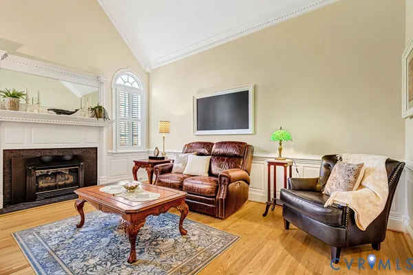 a view of a hallway with wooden floor and stairs
