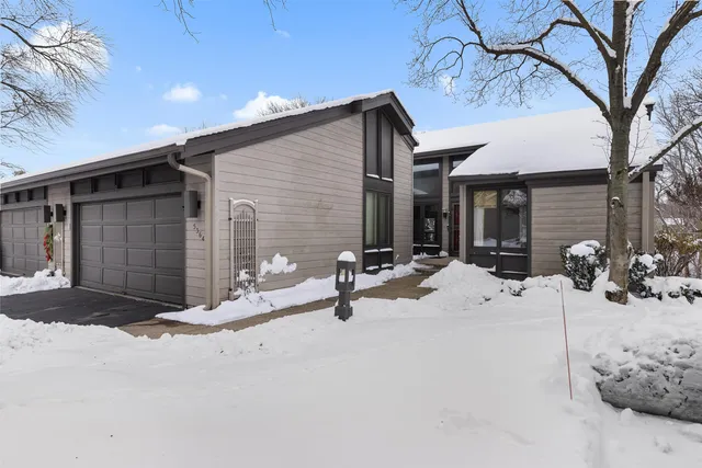 a view of a house with snow on the road