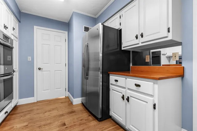 a kitchen with stainless steel appliances a refrigerator stove and cabinets