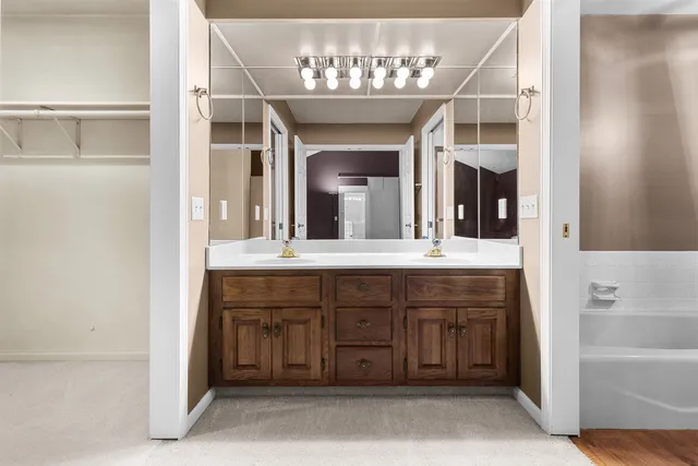 a bathroom with a sink and a large mirror