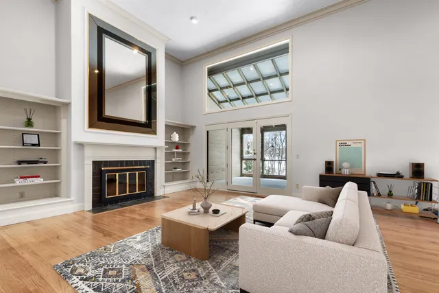 a living room with furniture a fireplace and wall painting