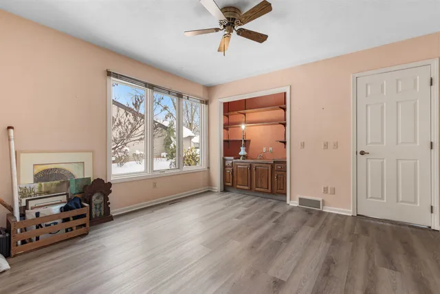 a view of a livingroom with a window and a hardwood