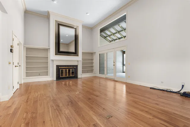 wooden floor fireplace and natural light in room