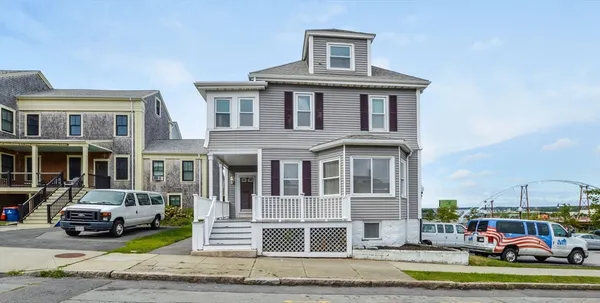 a front view of a residential apartment building with a yard