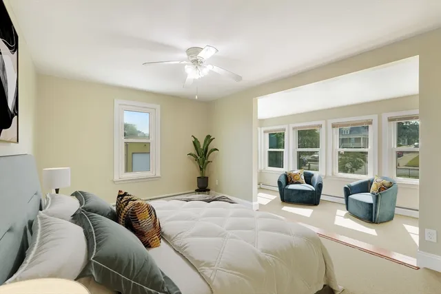 a spacious bedroom with a bed and wooden floor