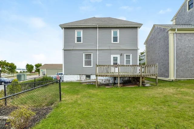 a view of a house with a yard and sitting area
