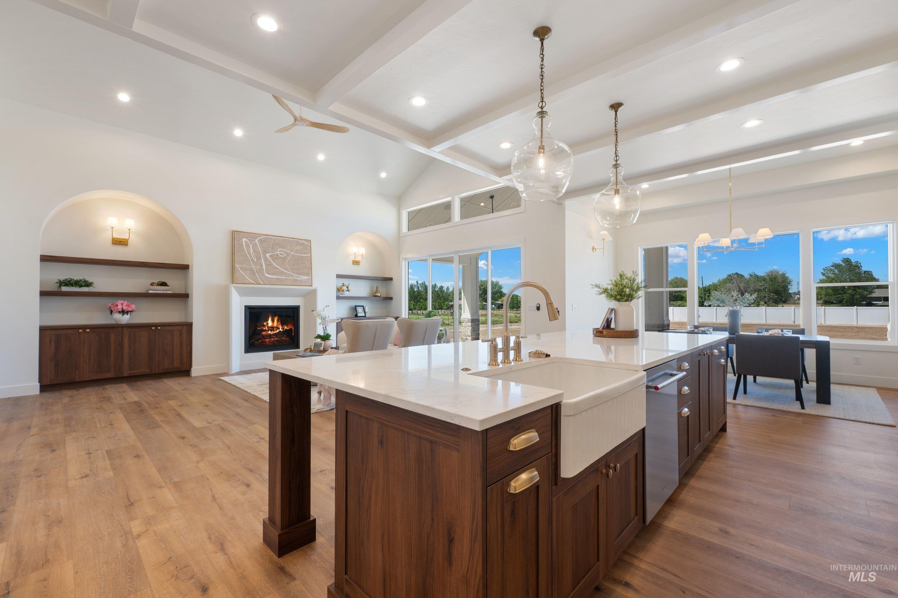 24821 Ardmore Court Caldwell, ID 83607 - Photo 18 of 43 Spacious kitchen island featuring a farmhouse sink, integrated dishwasher, and brass hardware