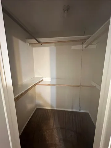 en empty room with windows and fan