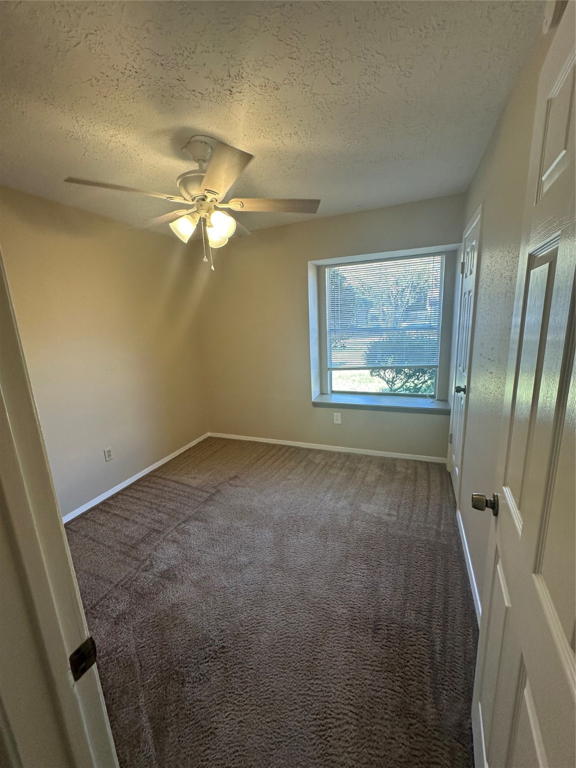 4727 Roserock Lane Spring, TX 77388 - Photo 14 of 14 en empty room with windows and fan