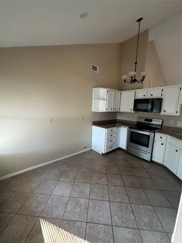 a kitchen with stainless steel appliances a stove a sink and cabinets