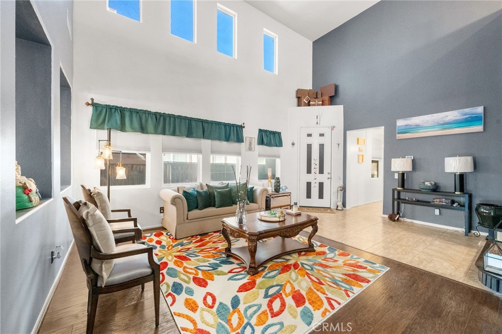 38327 Rancho Vista Drive Beaumont, CA 92223 - Photo 13 of 48 a living room with furniture and a floor to ceiling window