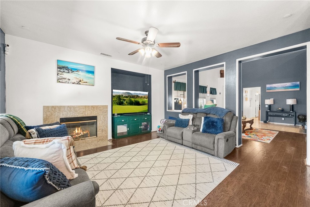 38327 Rancho Vista Drive Beaumont, CA 92223 - Photo 19 of 48 a living room with furniture a fireplace and a flat screen tv