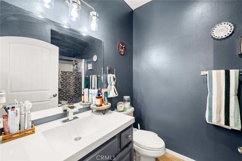 38327 Rancho Vista Drive Beaumont, CA 92223 - Photo 23 of 48 a bathroom with a sink vanity mirror and toilet