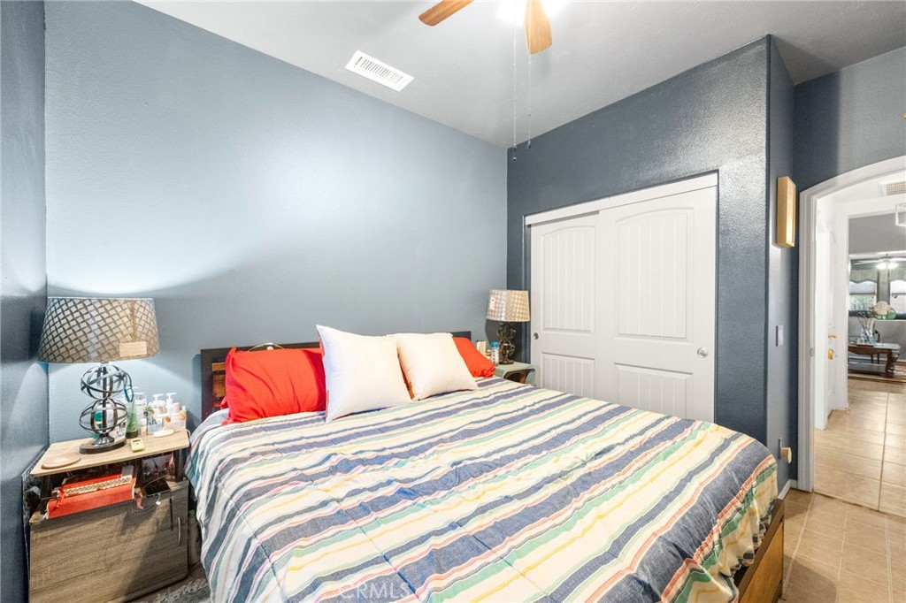 38327 Rancho Vista Drive Beaumont, CA 92223 - Photo 25 of 48 a bedroom with a bed and a chandelier