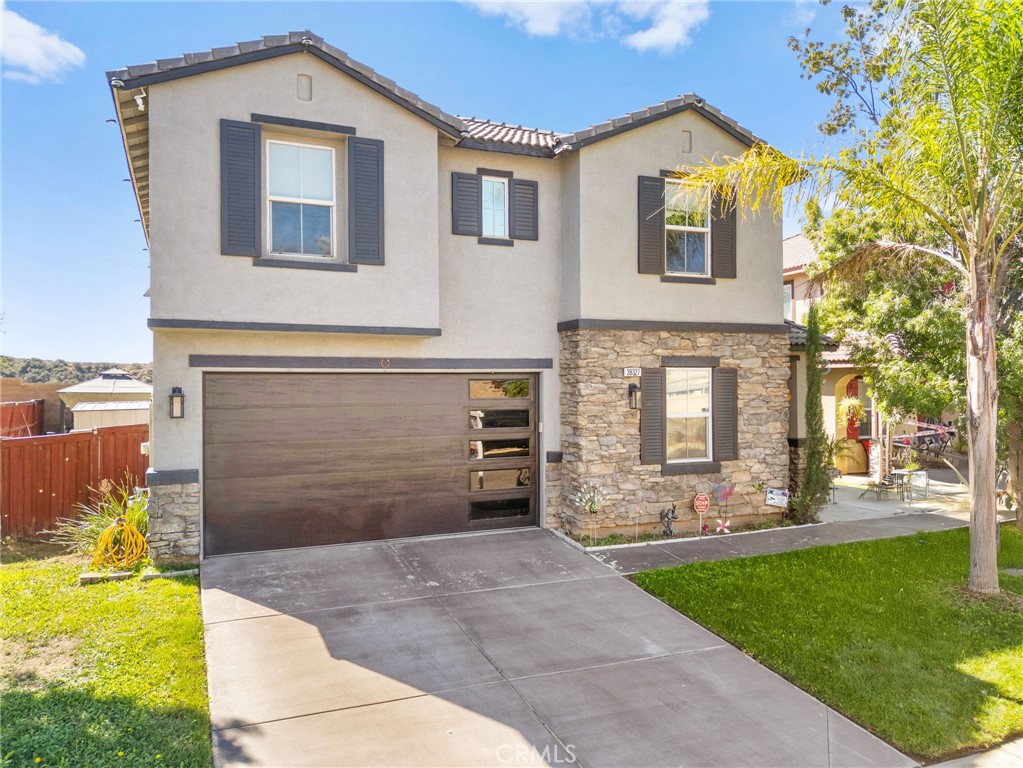38327 Rancho Vista Drive Beaumont, CA 92223 - Photo 3 of 48 a front view of a house with garden