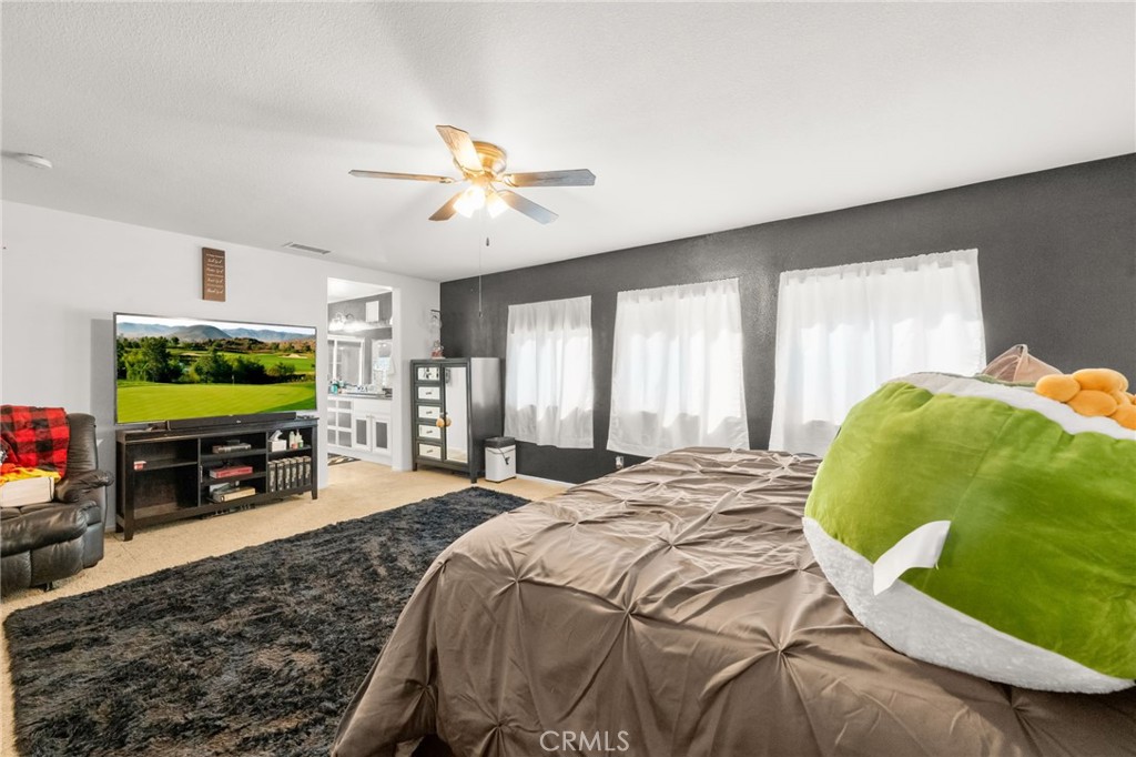 38327 Rancho Vista Drive Beaumont, CA 92223 - Photo 32 of 48 a bedroom with a bed television and a flat screen tv