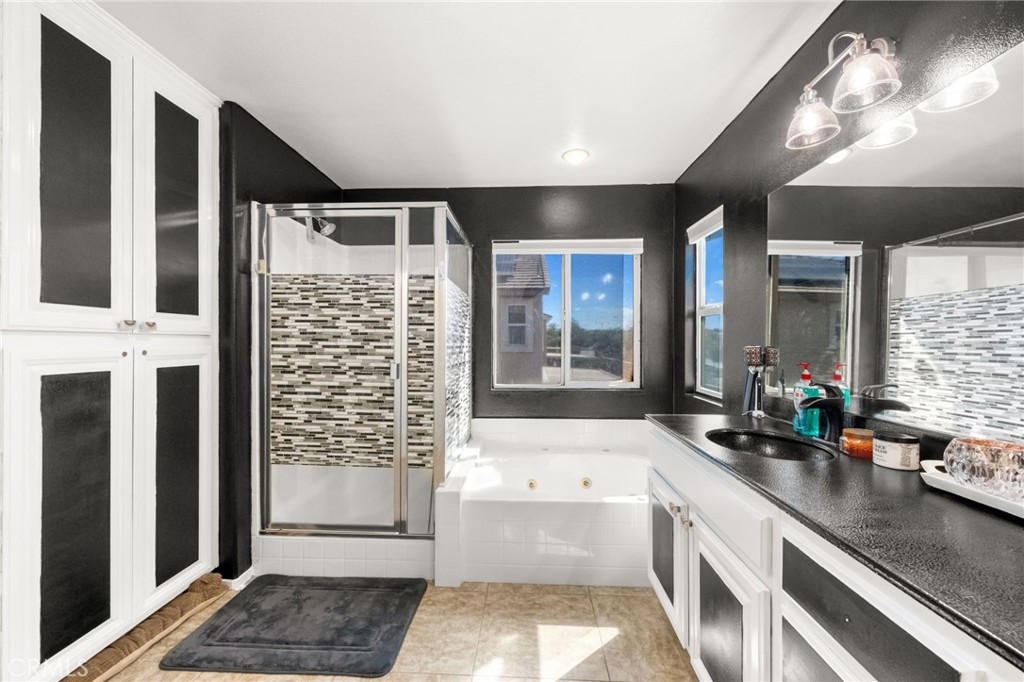 38327 Rancho Vista Drive Beaumont, CA 92223 - Photo 34 of 48 a bathroom with a tub sink and mirror