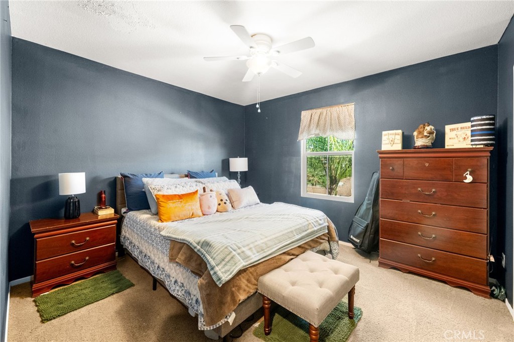 38327 Rancho Vista Drive Beaumont, CA 92223 - Photo 38 of 48 a bedroom with a bed and a dresser