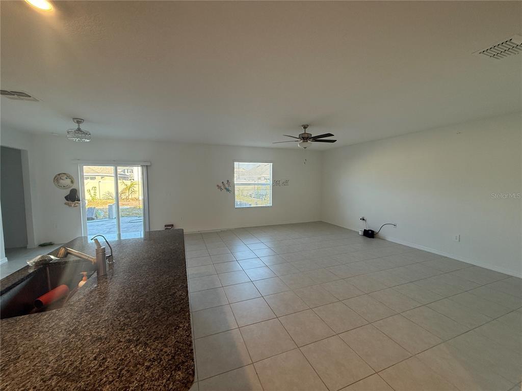 2881 Silver Scallop Loop Wimauma, FL 33598 - Photo 3 of 17 wooden floor in an empty room with a window