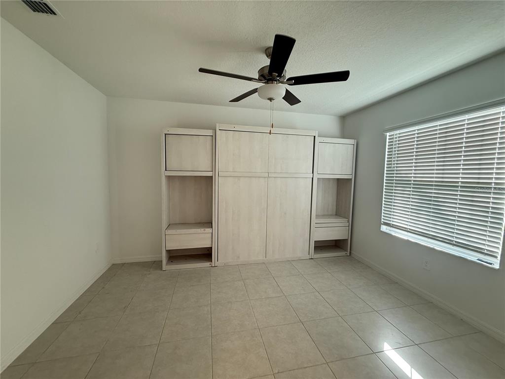 2881 Silver Scallop Loop Wimauma, FL 33598 - Photo 8 of 17 a view of an empty room with a window