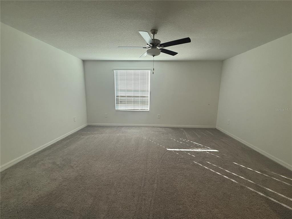 2881 Silver Scallop Loop Wimauma, FL 33598 - Photo 9 of 17 a view of an empty room with a window