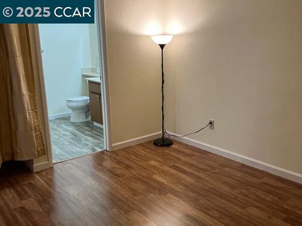 a view of a room with wooden floor