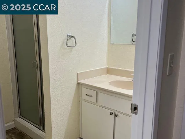 a bathroom with a shower and sink