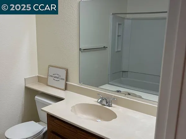 a bathroom with a sink toilet and vanity