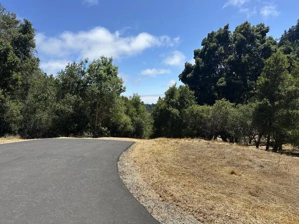 a view of white house with a snow on the road