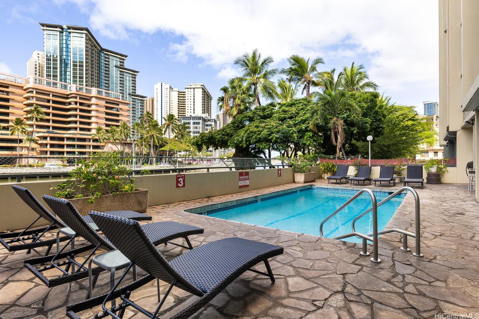 620 McCully Street, Unit 703 Honolulu, HI 96826 - Photo 19 of 25 The pool is alongside the canal.