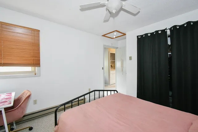 a bedroom with a bed and a window