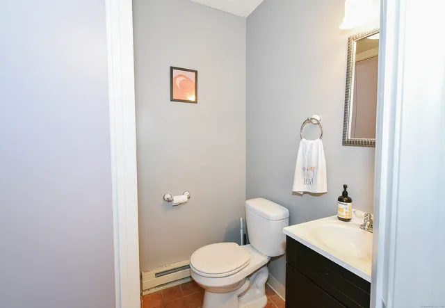 a bathroom with a sink a toilet and a mirror