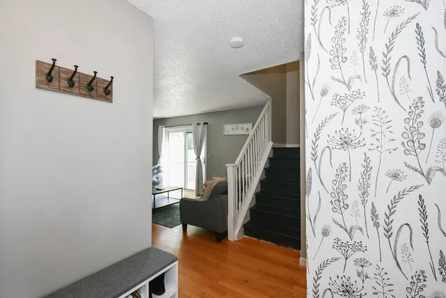a view of entryway and hall with wooden floor