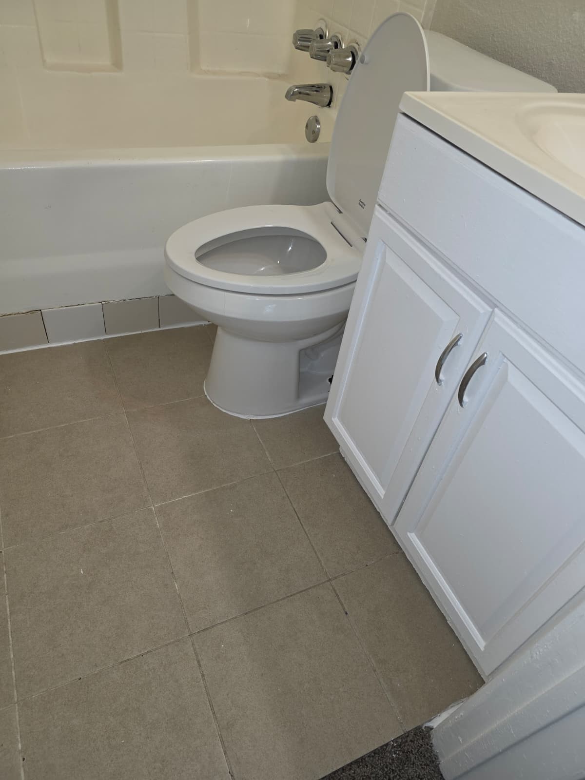 242 Bolden Street Houston, TX 77029 - Photo 23 of 24 a white toilet sitting next to a bath tub