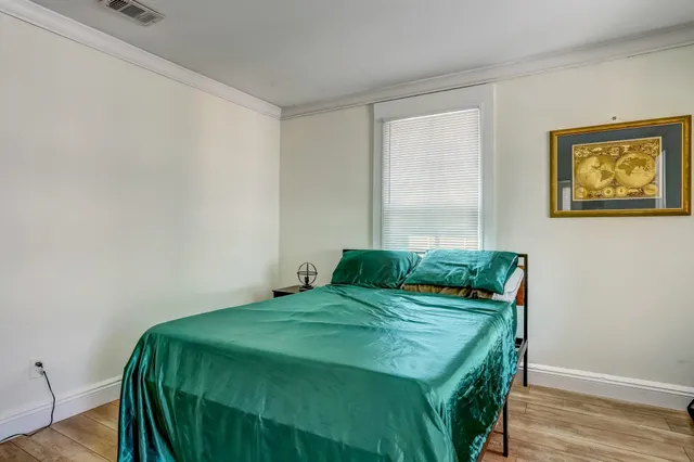 a bedroom with a bed and a window