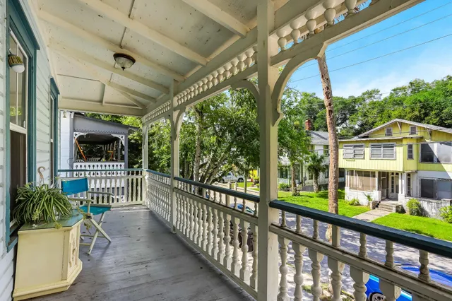 a view of a house with a porch and furniture