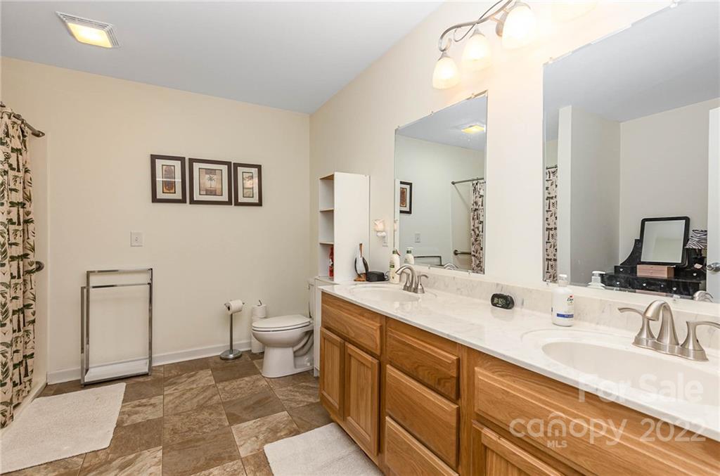 155 Rose Brier Lane. Salisbury, NC 28146 - Photo 16 of 32 a bathroom with a double vanity sink and a mirror